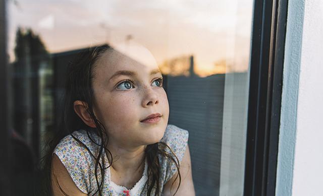Child staring out a window