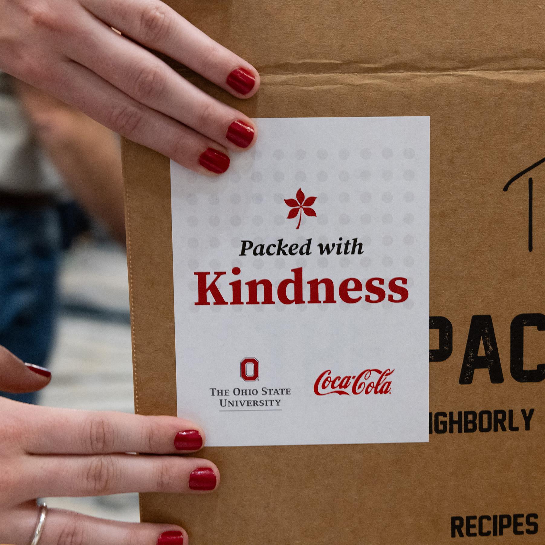 Buckeye Kindness label being placed on box