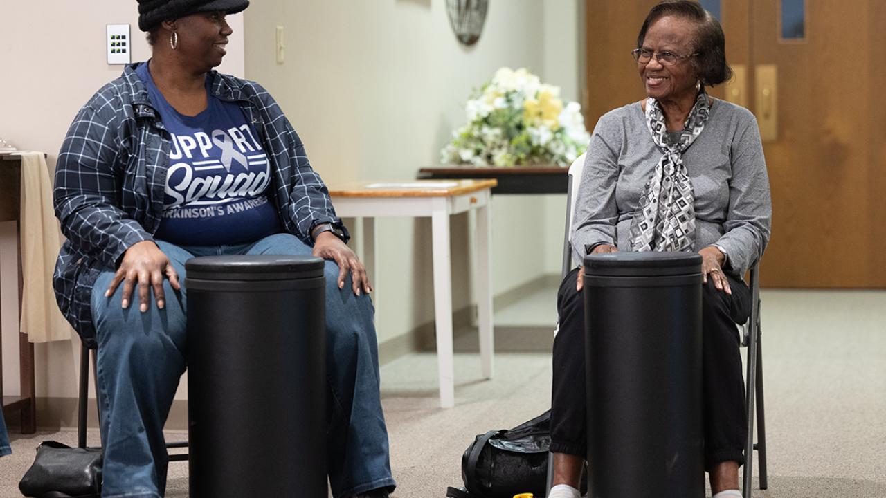 Ruthie Clemons (right) and her daughter Yolanda smile at one another during a recent Drumming for Wellness class at Ohio State Lima. 